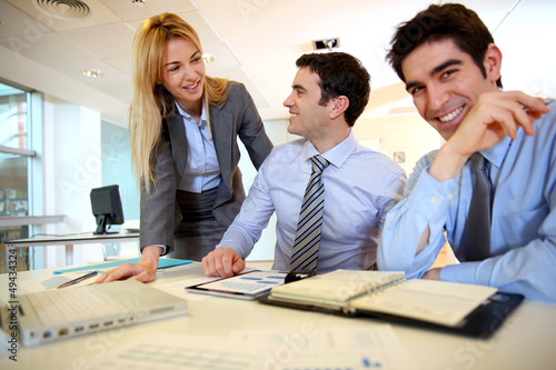 Photo: Business team working on sales results Business team working on sales results