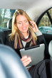 Photo: Woman going by taxi, she is on the phone Woman going by taxi, she is on the phone