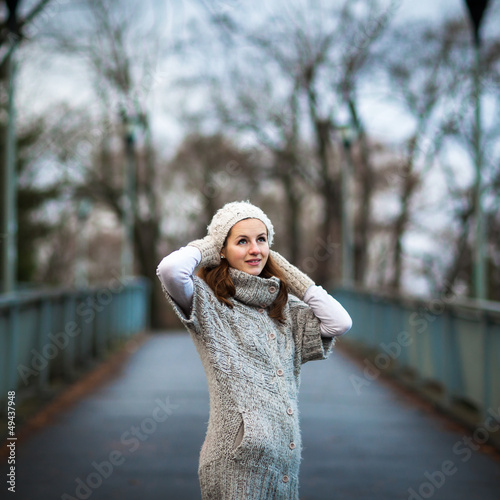 Photo: young woman dressed in a warm woolen cardigan young woman dressed in a warm woolen cardigan