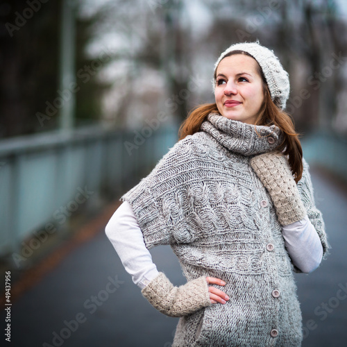 Photo: young woman dressed in a warm woolen cardigan young woman dressed in a warm woolen cardigan