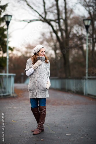 Photo: young woman dressed in a warm woolen cardigan young woman dressed in a warm woolen cardigan