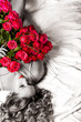 Woman with big bouquet of red roses