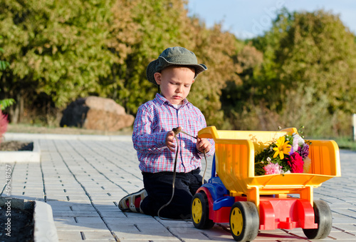 Photo: Cute little boy with a toy truck Cute little boy with a toy truck