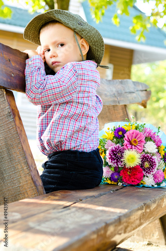 Photo: Little boy with a bouquet of flowers Little boy with a bouquet of flowers