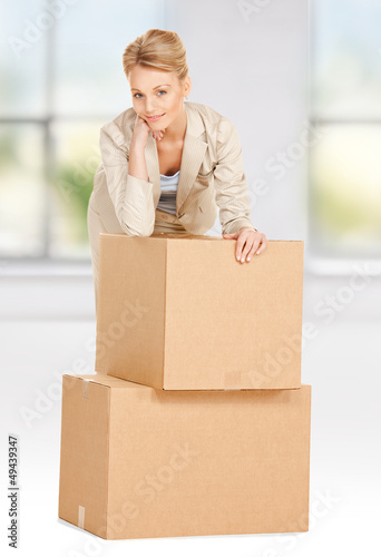 Photo: attractive businesswoman with big boxes attractive businesswoman with big boxes