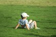 child relaxing on grass