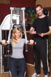 trainer and student in a gym