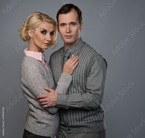 Photo: Elegant couple isolated on grey background Elegant couple isolated on grey background