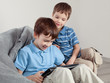 Two brothers playing on tablet
