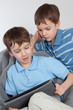 Two brothers playing on tablet