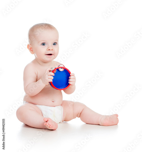 Photo: Baby playing with musical toy. Isolated on white background Baby playing with musical toy. Isolated on white background