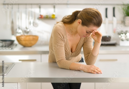 Photo: Stressed young woman in kitchen Stressed young woman in kitchen