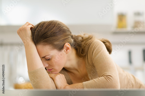 Photo: Stressed young housewife in kitchen Stressed young housewife in kitchen
