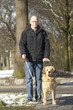 Guide dog is helping a blind man in traffic