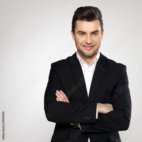Photo: Portrait of smiling businessman in black suit Portrait of smiling businessman in black suit