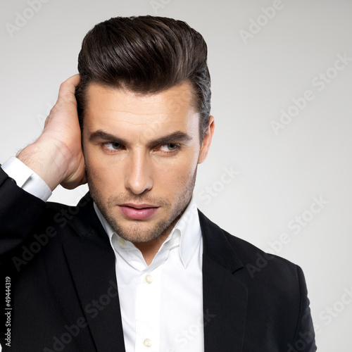 Photo: Closeup face of a fashion businessman in suit Closeup face of a fashion businessman in suit