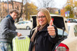 Photo: Young woman in front of taxi Young woman in front of taxi
