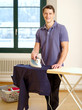 Photo: Attractive male ironing his shirt Attractive male ironing his shirt