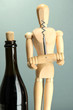 Mannequin with corkscrew and wine bottle, on grey background