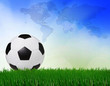 soccer football on green field with blue sky background