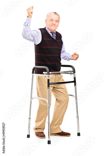 Photo: Happy mature gentleman with walker gesturing happiness Happy mature gentleman with walker gesturing happiness