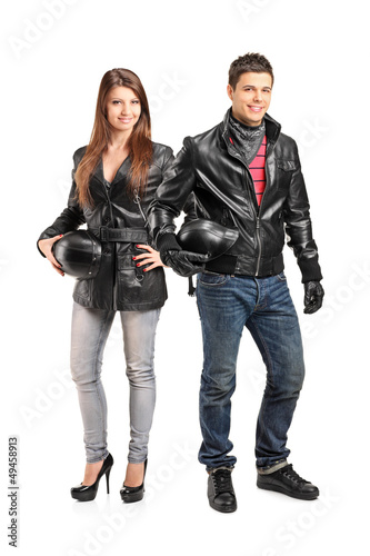 Photo: Full length portrait of two young motorcyclers in a leather jack Full length portrait of two young motorcyclers in a leather jack