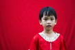 China boy in traditional Chinese red Tang suit greeting