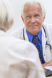 Senior Male Doctor With Female Patient