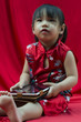 Photo: China girl in traditional Chinese red Tang suit greeting China girl in traditional Chinese red Tang suit greeting