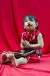 Photo: China girl in traditional Chinese red Tang suit greeting China girl in traditional Chinese red Tang suit greeting