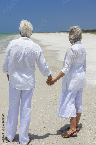 Photo: Happy Senior Couple Holding Hands on Tropical Beach Happy Senior Couple Holding Hands on Tropical Beach