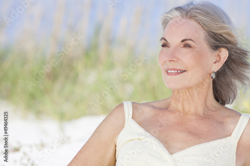 Photo: Attractive Senior Woman Sitting At Beach Attractive Senior Woman Sitting At Beach
