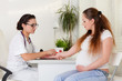 Pregnant woman and doctor.
