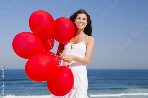 Photo: Beautiful girl holding red ballons Beautiful girl holding red ballons