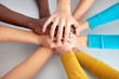 Foto: Team of friends showing unity with their hands together Team of friends showing unity with their hands together