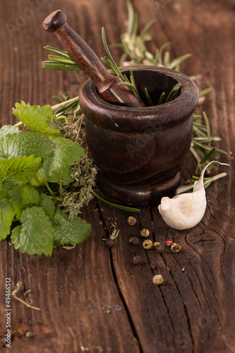 Photo: garlic and herbs in mortar garlic and herbs in mortar