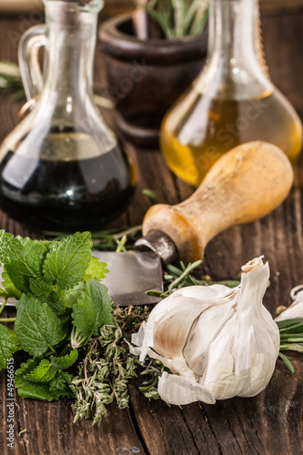 Photo: oil and vinegar, gralic, knife and herbs oil and vinegar, gralic, knife and herbs