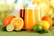 Glasses of juise with leafs and fruits