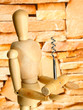 Mannequin with corkscrew, on brown wall background