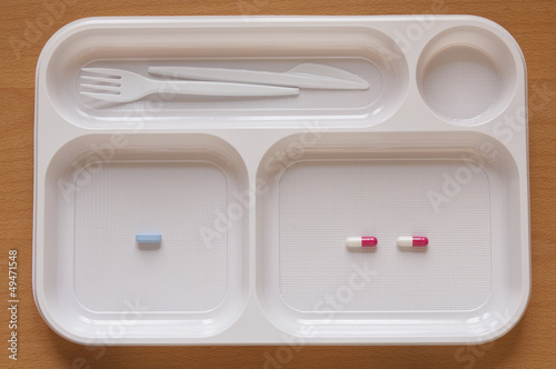 Photo: Close-up view of Pills in a food tray Close-up view of Pills in a food tray