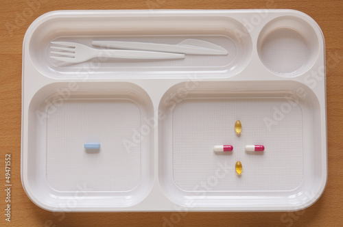 Photo: Close-up view of Pills in a food tray Close-up view of Pills in a food tray