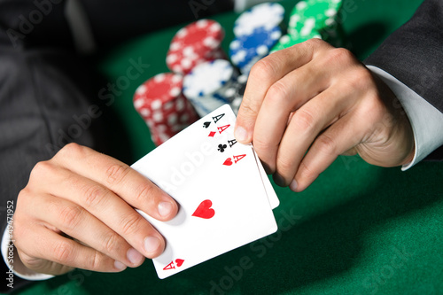 Photo: Gambler shows poker cards 4 aces Gambler shows poker cards 4 aces