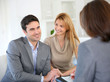 Cheerful couple receiving good news from advisor