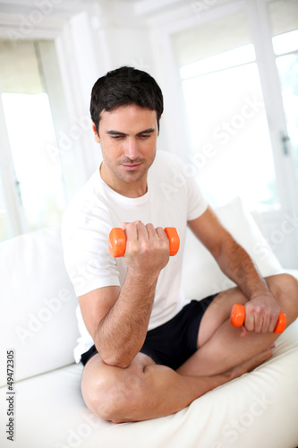 Photo: Man exercising with dumbbells in the morning Man exercising with dumbbells in the morning