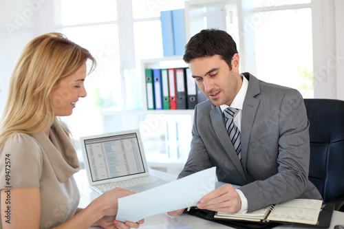 Photo: Woman meeting banker to set up her own business Woman meeting banker to set up her own business