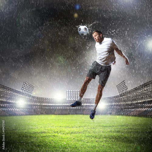 Photo: football player striking the ball football player striking the ball