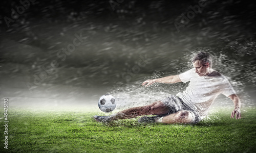 Photo: football player striking the ball football player striking the ball