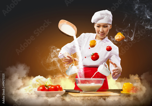 Photo: Asian female cooking with magic Asian female cooking with magic