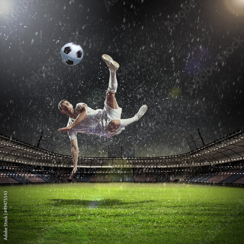 Photo: football player striking the ball football player striking the ball