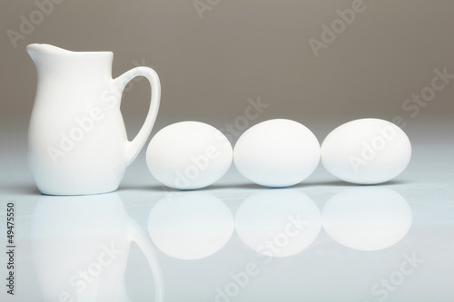Photo: Milk in a glass jar and eggs Milk in a glass jar and eggs